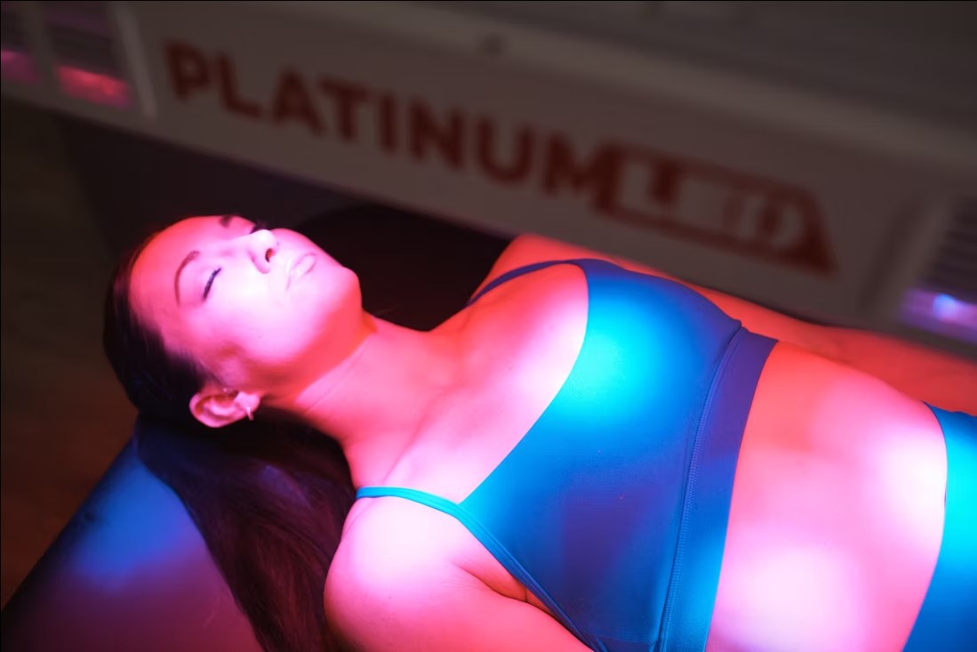 Client using red light therapy at Reset Wellness